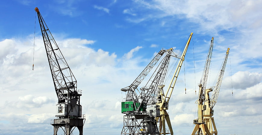 Industrial Cranes Against Blue Sky