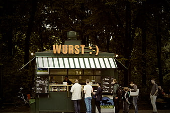 German sausage stand in park with customers