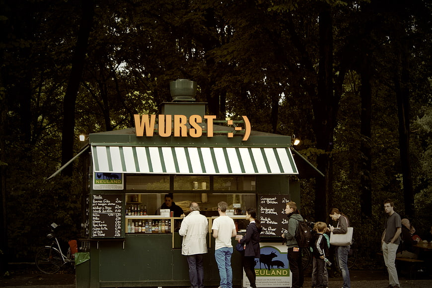 German sausage stand in park with customers