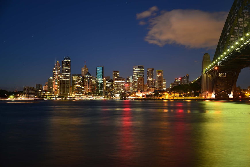 Sydney Skyline and Harbour Bridge at Night with Water Reflections