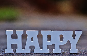 White Happy Letters On Blurred Outdoor Background