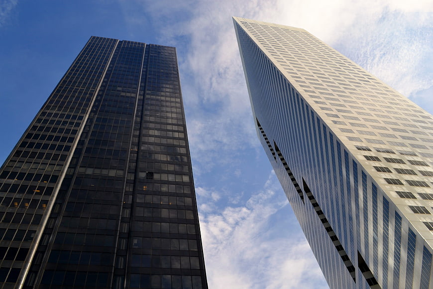 Low angle view of modern skyscrapers against blue sky