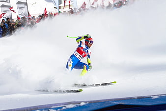 Alpine skier carving turn in powder snow
