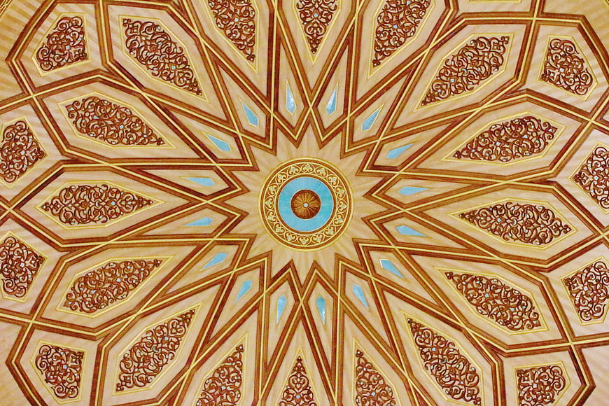Intricate Islamic geometric ceiling pattern with gold and blue details