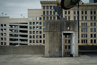 Concrete elevator shaft on urban parking garage rooftop