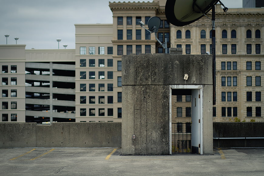 Concrete elevator shaft on urban parking garage rooftop