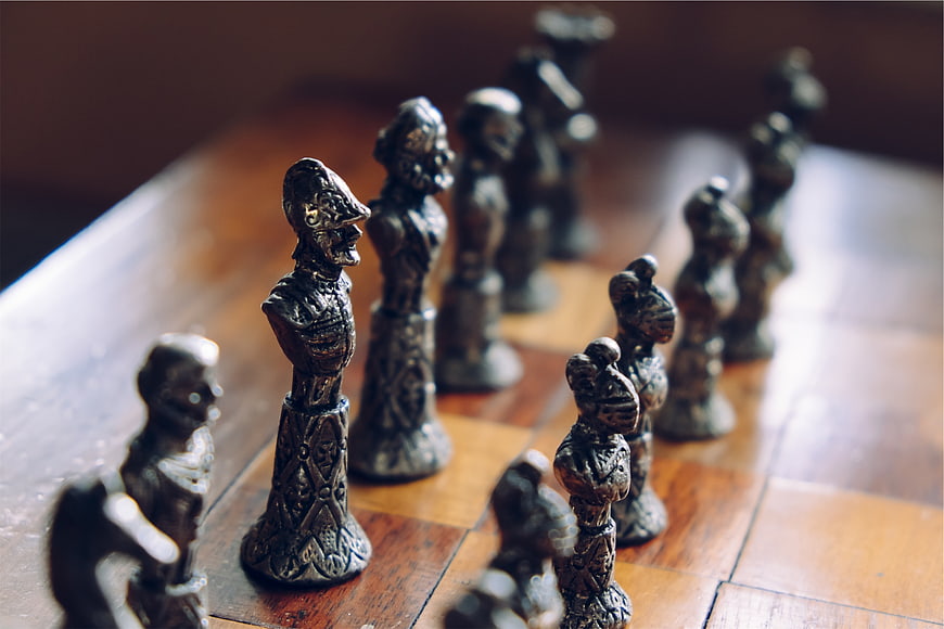Vintage ornate chess pieces on wooden board