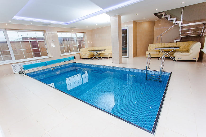 Luxurious Indoor Swimming Pool with Beige Lounge Area