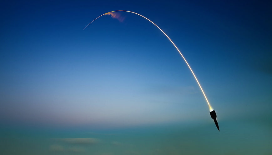 SpaceX Falcon 9 Rocket Launching Over Earth's Curvature