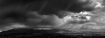 Dramatic Black and White Storm Clouds Over Mountain City Panorama