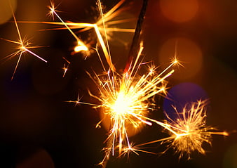 Golden Sparkler Sparks Against Dark Background