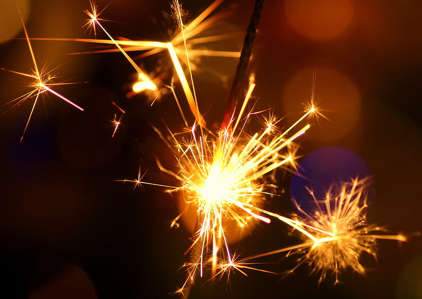 Golden Sparkler Sparks Against Dark Background