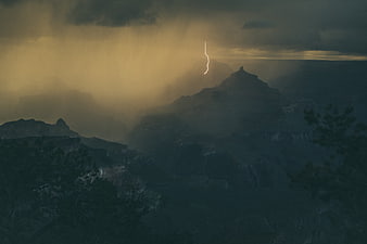 Dramatic Lightning Strike Over Misty Mountain Landscape
