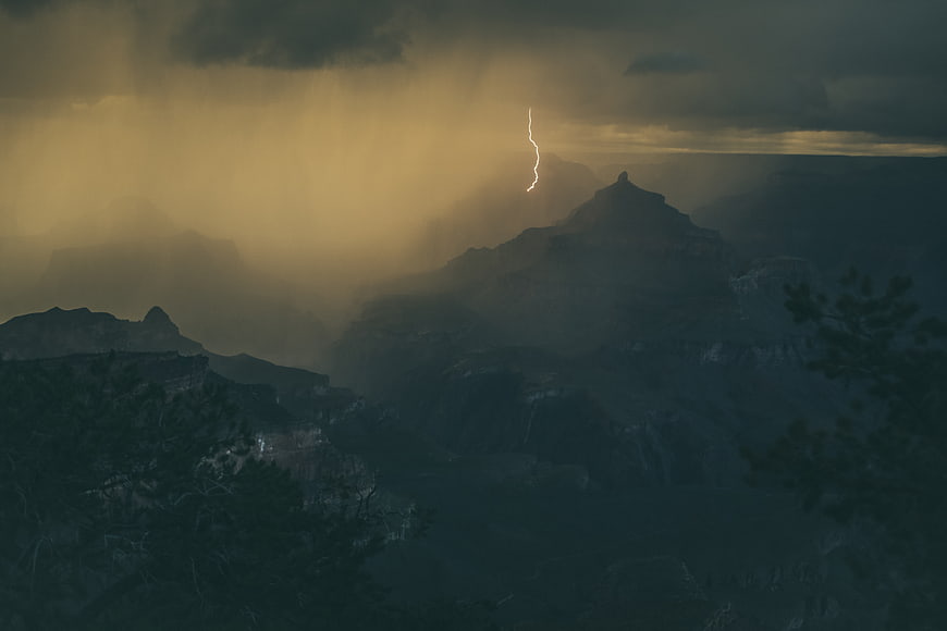 Dramatic Lightning Strike Over Misty Mountain Landscape
