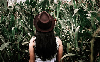 Woman in Fedora Hat Standing in Cornfield