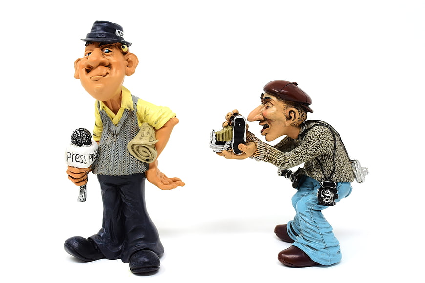 Caricature Figurines of Journalist and Photographer on White Background