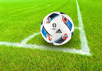 Soccer ball on corner of green grass field