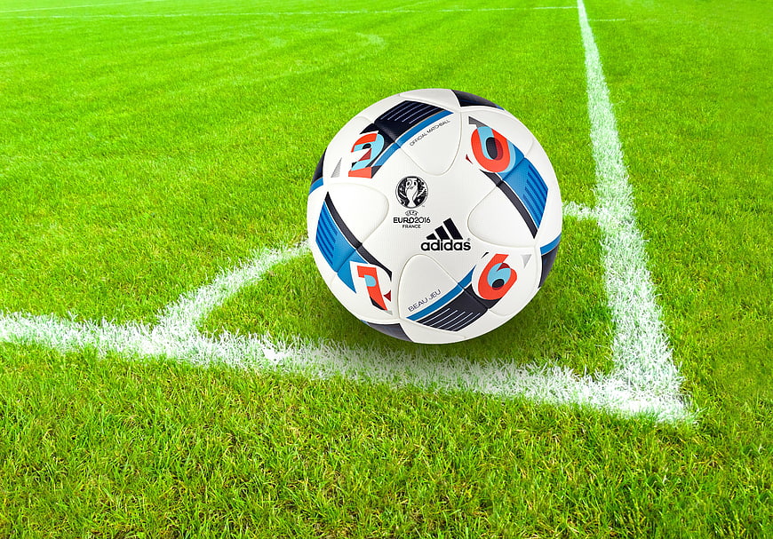 Soccer ball on corner of green grass field