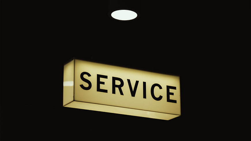 Illuminated Service Sign Hanging in Dark Interior