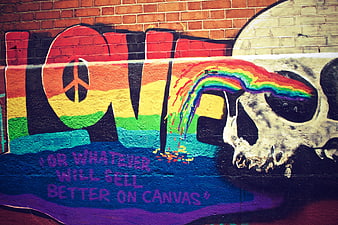 Colorful Graffiti Art with Skull and Rainbow on Brick Wall