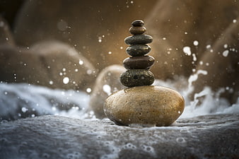 Stacked Zen Stones in Ocean Waves