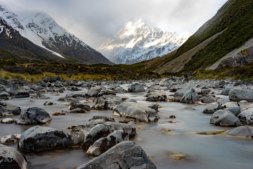 Majestic Snow-Capped Mountains and Rocky River Valley Landscape