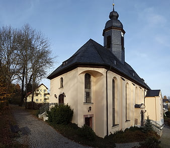 Historic European Church with Onion Dome Tower in Autumn
