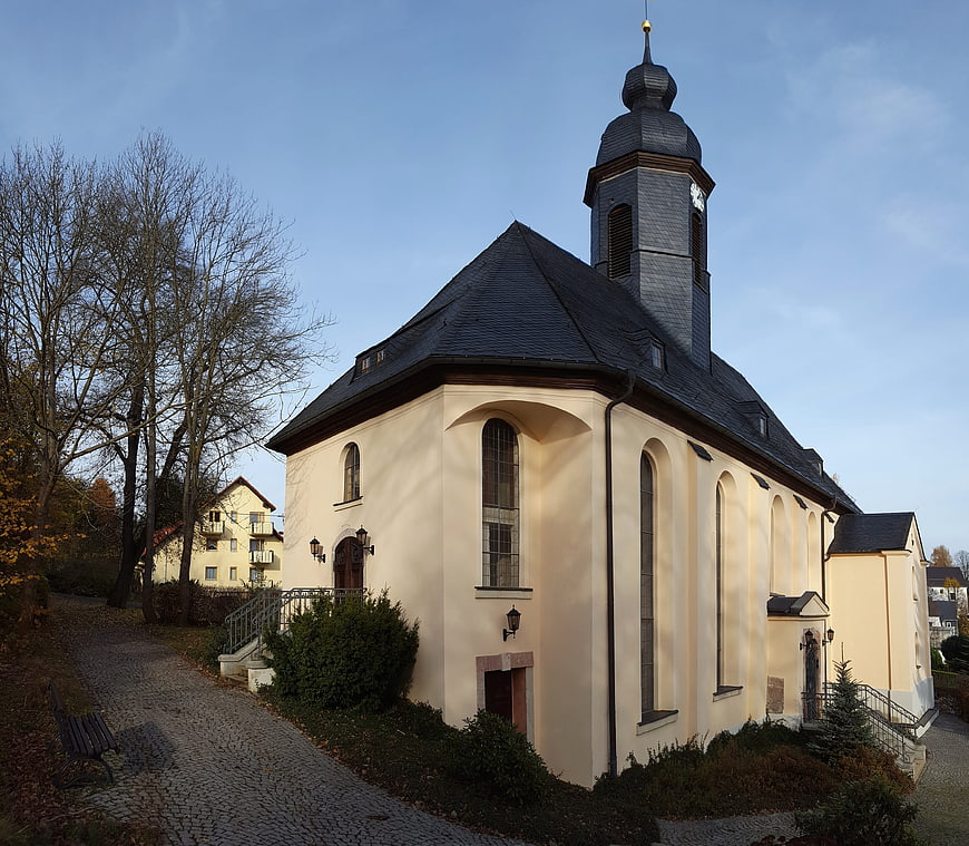 Historic European Church with Onion Dome Tower in Autumn