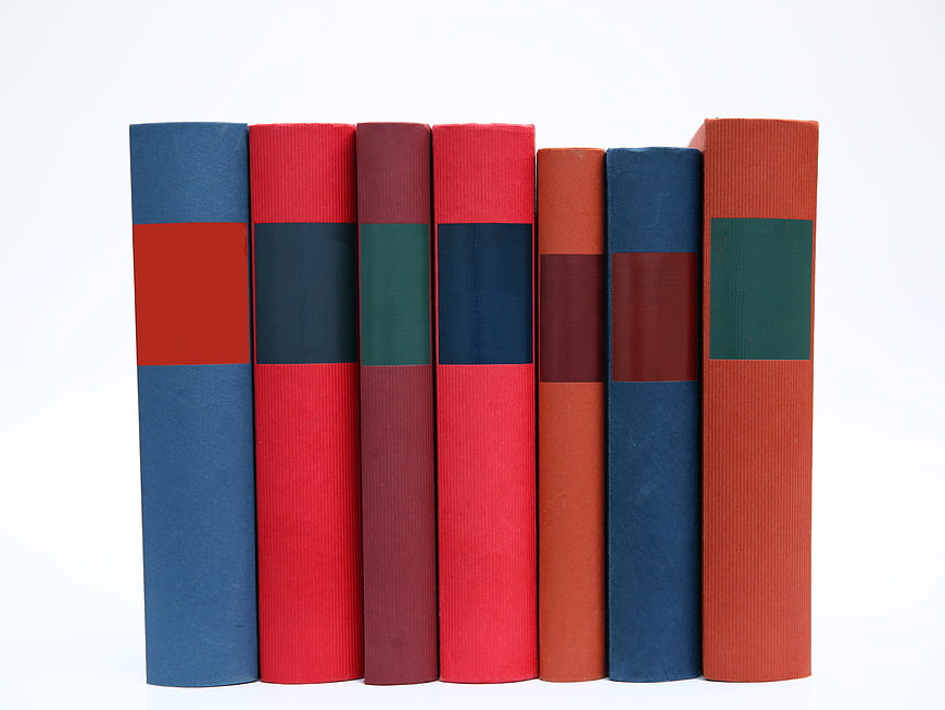 Colorful Hardcover Books Spines on White Background