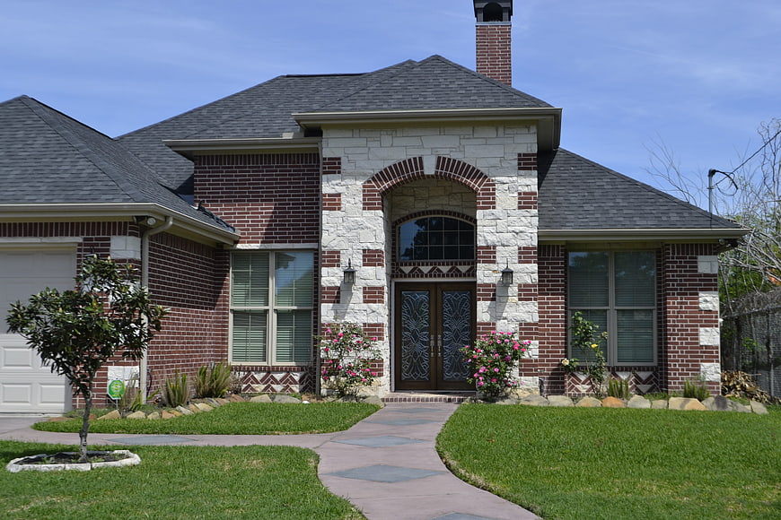 Front Exterior of Brick and Stone Suburban House