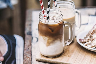 Iced Coffee in Mason Jars with Striped Straws on Wooden Table
