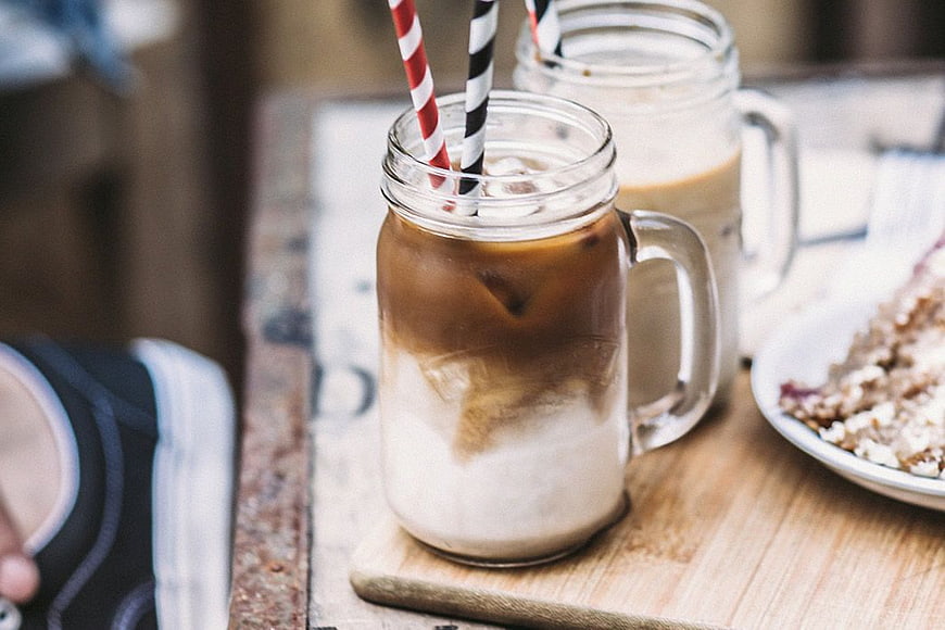 Iced Coffee in Mason Jars with Striped Straws on Wooden Table