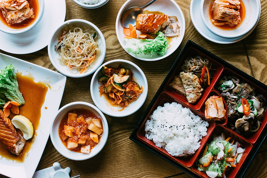 Top View of Traditional Korean Meal with Bento Box and Side Dishes