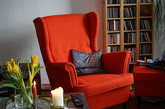 Cozy Orange Wingback Armchair With Tulips And Candles In Living Room