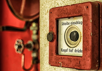 Vintage red fire alarm button with German text