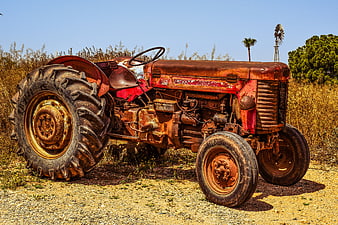 Rusted Vintage Farm Tractor In Rural Countryside Landscape