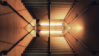 Symmetrical Staircase with Dramatic Lighting and Handrails