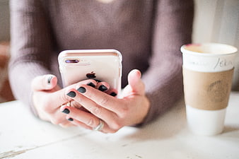 Woman Hands Using Smartphone with Coffee Cup