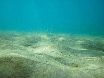 Underwater Sandy Ocean Floor with Blue Water Background