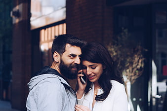 Couple Sharing A Moment On A Smartphone In An Urban Setting