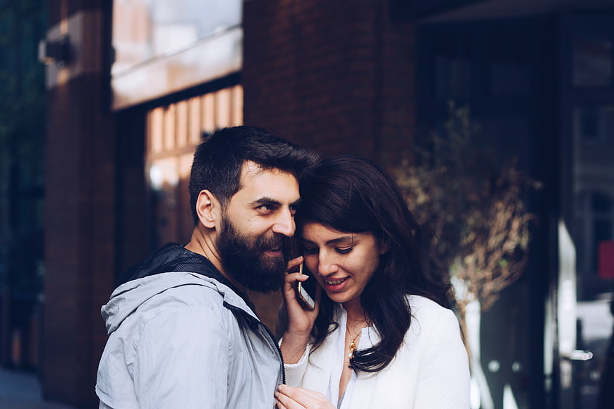 Couple Sharing A Moment On A Smartphone In An Urban Setting