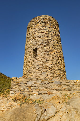 Ancient Stone Watchtower Against Blue Sky in Cinque Terre