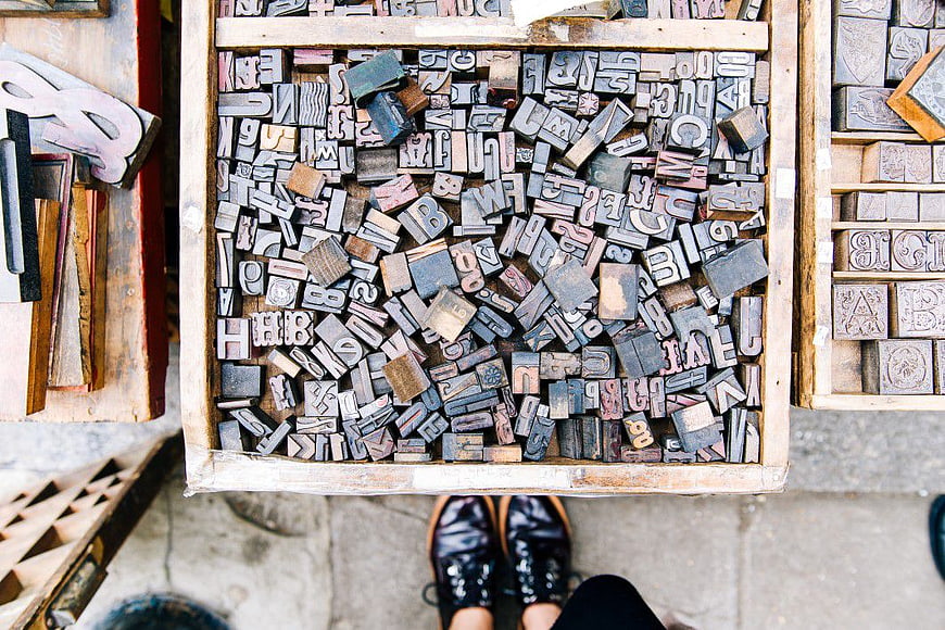 Vintage wooden letterpress blocks in a crate