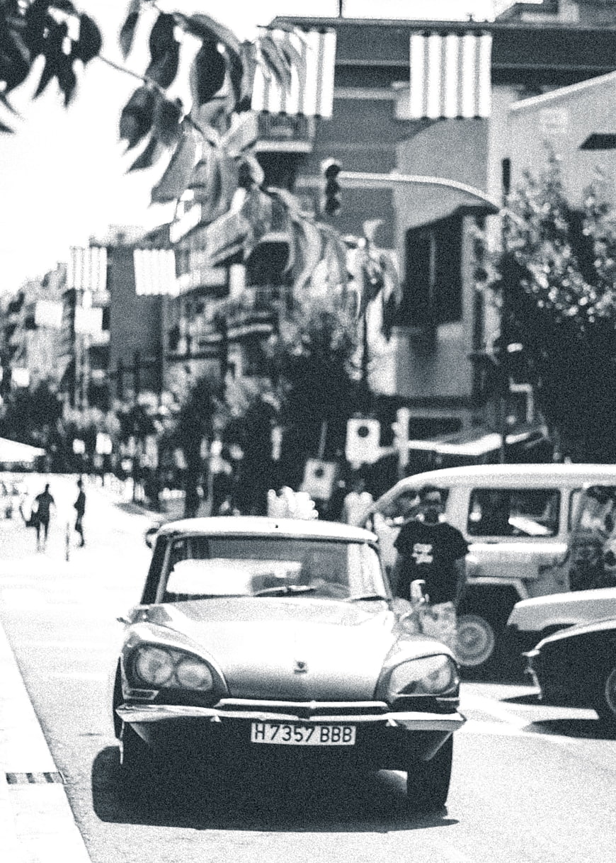 Vintage black and white photo of classic car on city street