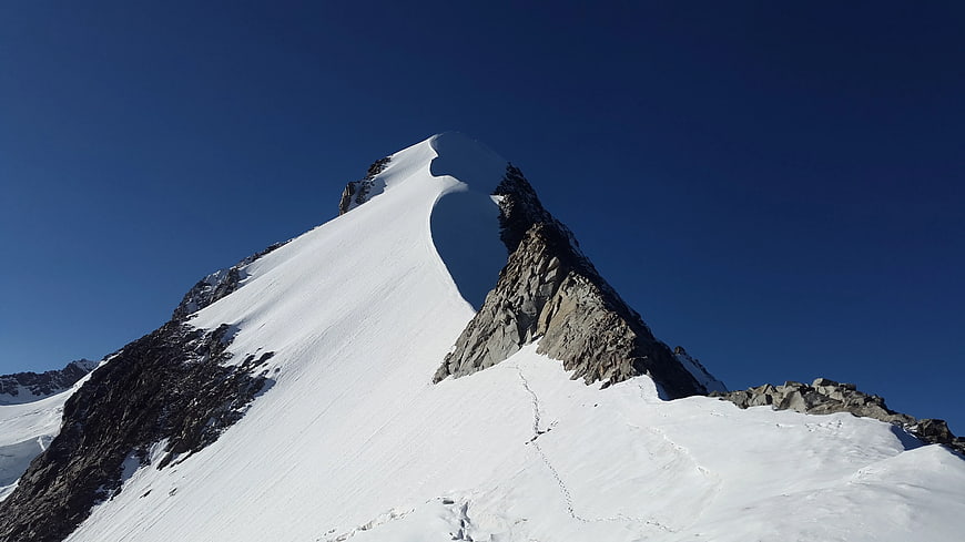 Snowy Mountain Peak Against Blue Sky