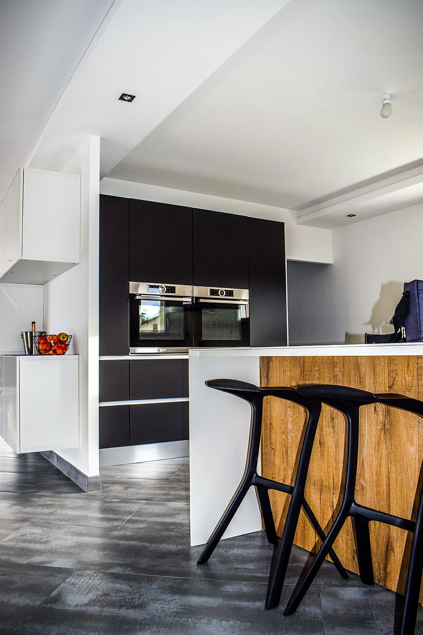 Modern Kitchen Interior with Black Cabinets and Wooden Island
