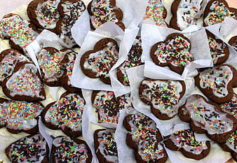 Heart-shaped chocolate cookies with white icing and sprinkles