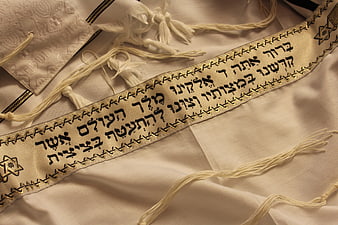 Close-up of Jewish Tallit Prayer Shawl with Hebrew Text