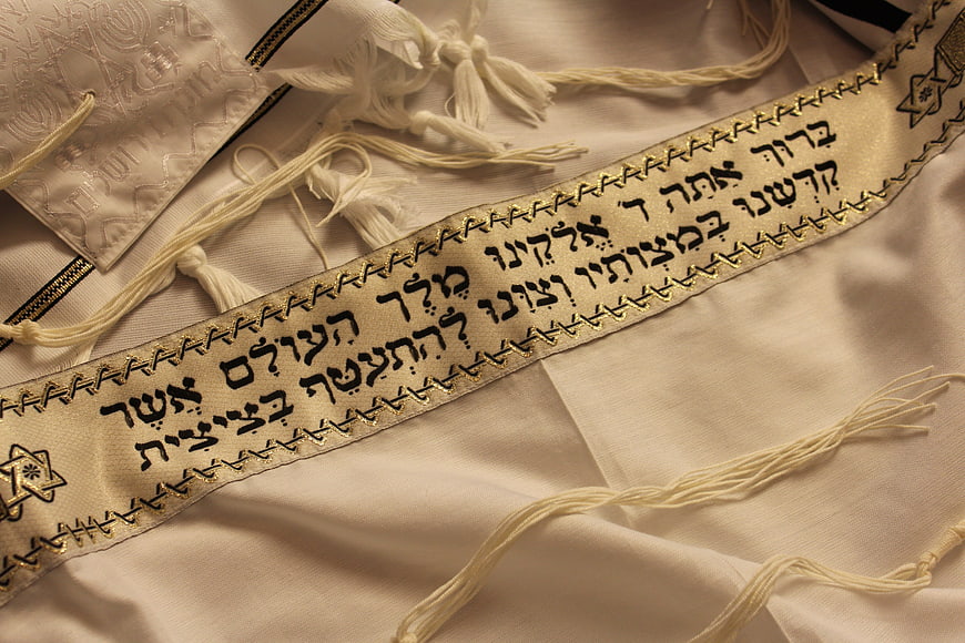 Close-up of Jewish Tallit Prayer Shawl with Hebrew Text