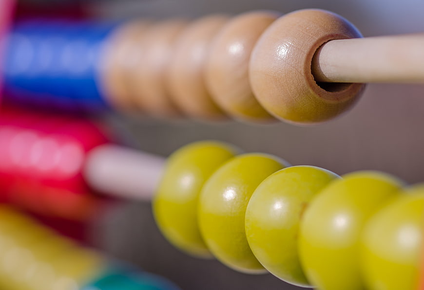 Close-up of wooden abacus beads for education and math